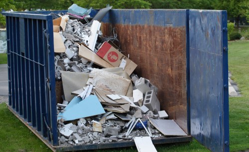 Demolition site in Wimbledon with waste materials being removed
